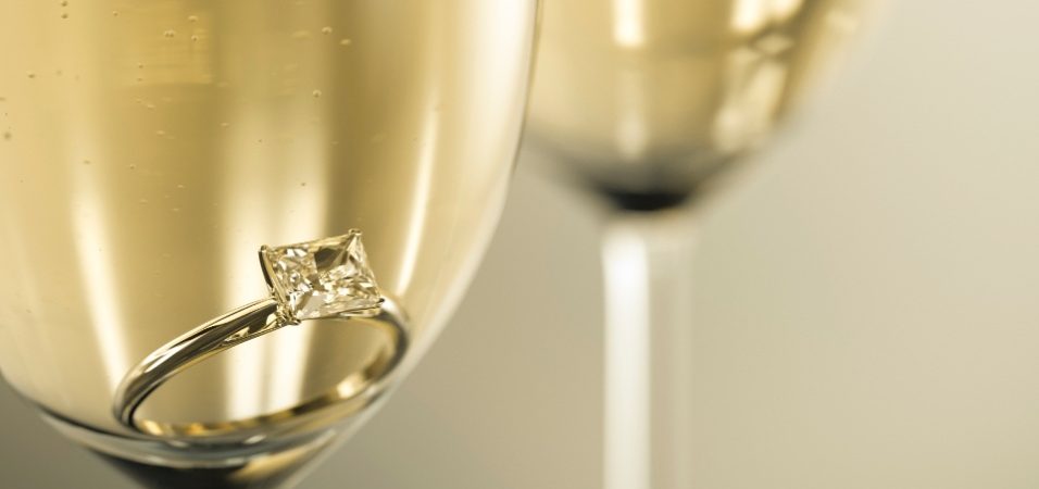 Embrace-Bliss-Champagne-Glasses-With-Engagement-Ring-574×250